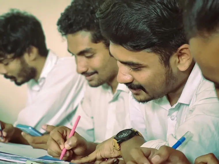 Engineering students taking notes together