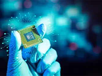 Gloved hand holding a microchip