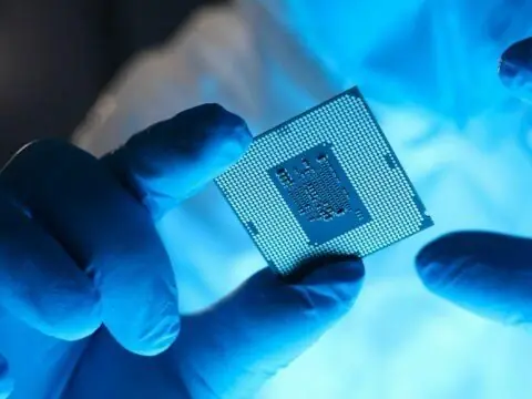 Underside of a packaged processor held with gloves