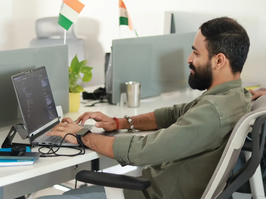 Engineer writing code on a laptop